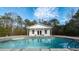 Inviting pool with a pool house and wooded backdrop at 3246 E 5 E Hwy, Carrollton, GA 30116