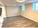 Finished basement with neutral walls and laminate floors at 3464 Creatwood Se Trl, Smyrna, GA 30080