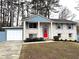 Brick ranch house with red door, attached garage, and landscaped yard at 3464 Creatwood Se Trl, Smyrna, GA 30080