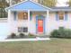 Brick ranch house with blue accents, red door, and landscaped yard at 3464 Creatwood Se Trl, Smyrna, GA 30080