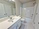 Bathroom featuring a quartz vanity, mirror, and bathtub with shower at 5435 Rock Place Ct # 38, Norcross, GA 30093