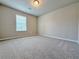 Bedroom with neutral colored walls, carpet flooring and window with blinds at 5435 Rock Place Ct # 38, Norcross, GA 30093