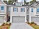 Modern two-story townhome with gray siding and attached garage at 5435 Rock Place Ct # 38, Norcross, GA 30093