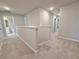 Upstairs hallway with carpet flooring and entry to bathroom at 5435 Rock Place Ct # 38, Norcross, GA 30093