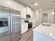 View of the kitchen showcasing stainless steel appliances, white cabinets, and quartz countertops at 5435 Rock Place Ct # 38, Norcross, GA 30093