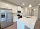 Modern kitchen featuring white cabinets, stainless steel appliances, and an island with quartz countertop at 5435 Rock Place Ct # 38, Norcross, GA 30093