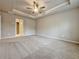 Spacious carpeted main bedroom with neutral walls, a ceiling fan, and ample space at 5435 Rock Place Ct # 38, Norcross, GA 30093