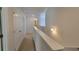 Upstairs hallway with carpet and doors to bedrooms at 80 Heyman Dr, Covington, GA 30016