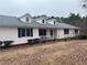 Charming home featuring a white exterior, dormer windows, a covered porch, and a well-maintained front yard at 850 Thurman Rd, Stockbridge, GA 30281