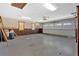 Attached garage with new white door, concrete flooring and wood-paneled walls at 850 Thurman Rd, Stockbridge, GA 30281
