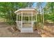A gazebo sits among mature trees in the backyard of the property at 850 Thurman Rd, Stockbridge, GA 30281