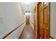 Long hallway with wood flooring and paneled doors, illuminated by recessed lighting at 850 Thurman Rd, Stockbridge, GA 30281