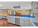 An open kitchen showcases ample counter space, white cabinets, a tile backsplash and wood floors at 850 Thurman Rd, Stockbridge, GA 30281