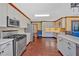 Spacious kitchen with stainless steel appliances, white cabinetry, and hardwood floors at 850 Thurman Rd, Stockbridge, GA 30281