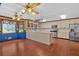 Open kitchen with white cabinets, hardwood floors, and a window overlooking a treed lawn at 850 Thurman Rd, Stockbridge, GA 30281