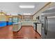 Bright kitchen with stainless steel appliances, white cabinets and wood flooring leading to a sunny dining area at 850 Thurman Rd, Stockbridge, GA 30281
