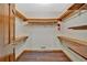 Spacious walk-in closet with wood floors, wood shelving, and a fire extinguisher at 850 Thurman Rd, Stockbridge, GA 30281