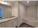 Bathroom with granite countertop, bathtub, and white cabinets at 140 Tye St, Stockbridge, GA 30281