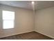 Bright bedroom featuring a large window and carpeted floors at 140 Tye St, Stockbridge, GA 30281