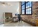 Bright home office features exposed brick, large window, and modern work space at 170 Boulevard Se # H401, Atlanta, GA 30312