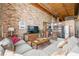 Open living space with exposed brick wall and modern kitchen at 170 Boulevard Se # H401, Atlanta, GA 30312