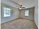 Bedroom with two windows, ceiling fan, and closet at 532 Greg Sw Dr, Lilburn, GA 30047