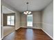 Formal dining room with hardwood floors and a chandelier at 532 Greg Sw Dr, Lilburn, GA 30047