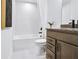 Bathroom with hexagonal tile, tub and dark brown vanity at 5395 Julep Ct, Cumming, GA 30028