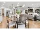 Open concept dining area with a large round table and hardwood floors at 5395 Julep Ct, Cumming, GA 30028