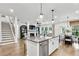 Modern kitchen with white cabinets, granite countertops and a large island with seating at 5395 Julep Ct, Cumming, GA 30028