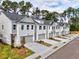 Row of charming townhomes with gray roofs and white brick exteriors, featuring landscaping and driveways at 5455 Rock Place Ct # 40, Norcross, GA 30093