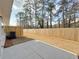 Fenced backyard, concrete patio, and mature trees at 5455 Rock Place Ct # 40, Norcross, GA 30093