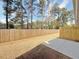 Fenced backyard with mature trees, concrete patio, and ample space at 5455 Rock Place Ct # 40, Norcross, GA 30093