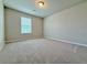 Cozy bedroom with neutral carpet, blind-covered windows, and ample natural light at 5455 Rock Place Ct # 40, Norcross, GA 30093