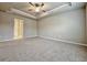 Neutral bedroom with plush carpet, ceiling fan, and en-suite bathroom at 5455 Rock Place Ct # 40, Norcross, GA 30093