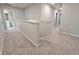 Upstairs hallway with neutral carpet and white trim leading to the rooms at 5455 Rock Place Ct # 40, Norcross, GA 30093