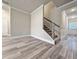 Living room with gray wood-look floors, stairway, and neutral walls at 5455 Rock Place Ct # 40, Norcross, GA 30093