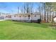 Front view of charming ranch house with stone accents and a grassy lawn at 205 Ridge Run, Stockbridge, GA 30281