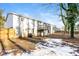 Rear view of house with deck, showing a partially snow covered yard at 205 Ridge Run, Stockbridge, GA 30281