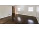 Spacious living room with dark hardwood floors and an accent wall at 205 Ridge Run, Stockbridge, GA 30281