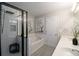 Bright bathroom featuring double vanity, soaking tub, and modern walk-in shower at 2353 Maplewood Se Ct # 25, Atlanta, GA 30339