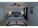 Inviting bedroom with a tufted headboard, soft lighting, ceiling fan, and stylish decor at 2353 Maplewood Se Ct # 25, Atlanta, GA 30339