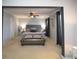 Spacious bedroom featuring gray walls, tufted headboard, ceiling fan, and stylish decor at 2353 Maplewood Se Ct # 25, Atlanta, GA 30339