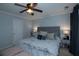 Comfortable bedroom with a tufted headboard, soft lighting, ceiling fan, and light blue walls at 2353 Maplewood Se Ct # 25, Atlanta, GA 30339