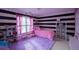 Fun bedroom design with striped walls, plush carpet, and whimsical decor at 2353 Maplewood Se Ct # 25, Atlanta, GA 30339