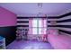 Bright bedroom with pink and black striped walls at 2353 Maplewood Se Ct # 25, Atlanta, GA 30339