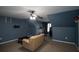 Bonus room offering a cozy seating area, ceiling fan, and dark accent wall at 2353 Maplewood Se Ct # 25, Atlanta, GA 30339
