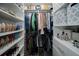 Organized walk-in closet featuring shelving for shoes and storage bins for accessories and folded clothes at 2353 Maplewood Se Ct # 25, Atlanta, GA 30339