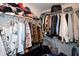 Walk-in closet with hanging clothes on rods and folded apparel on overhead shelving at 2353 Maplewood Se Ct # 25, Atlanta, GA 30339