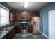 Modern kitchen with stainless steel appliances and dark wood cabinets at 2353 Maplewood Se Ct # 25, Atlanta, GA 30339